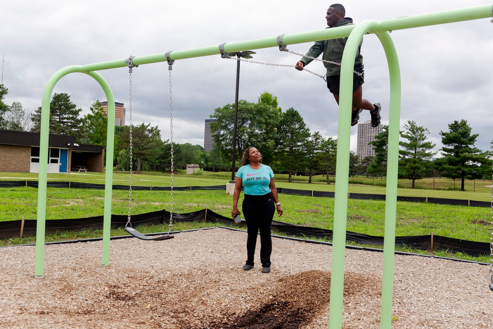 Adrienne Hazel watches her son Ricky as he plays on a swing on Thursday, July 17, 2025, in Southfield, Mich. (AP Photo/Sylvia Jarrus)