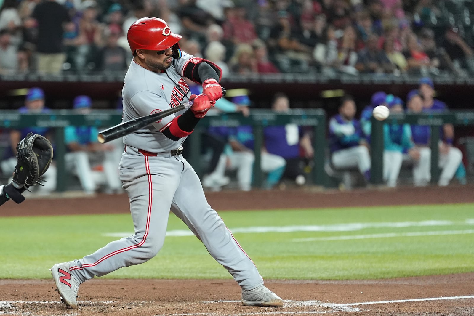 Cincinnati Reds' Jose Trevino starts his swing on a run-scoring single against the Arizona Diamondbacks during the second inning of a baseball game Friday, Aug. 22, 2025, in Phoenix. (AP Photo/Ross D. Franklin)