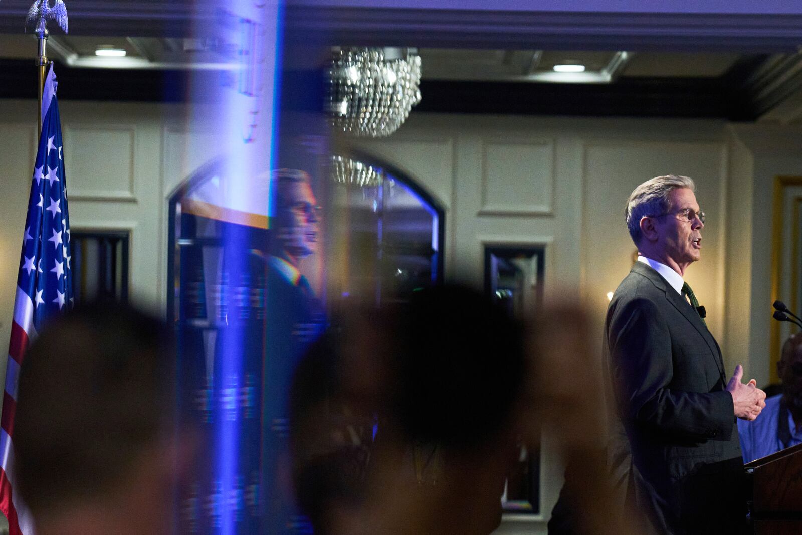 Treasury Secretary Scott Bessent is reflected in a mirror as he speaks, Wednesday, April 23, 2025, to the Institute of International Finance Global Outlook Forum at the Willard Hotel in Washington. (AP Photo/Jacquelyn Martin)