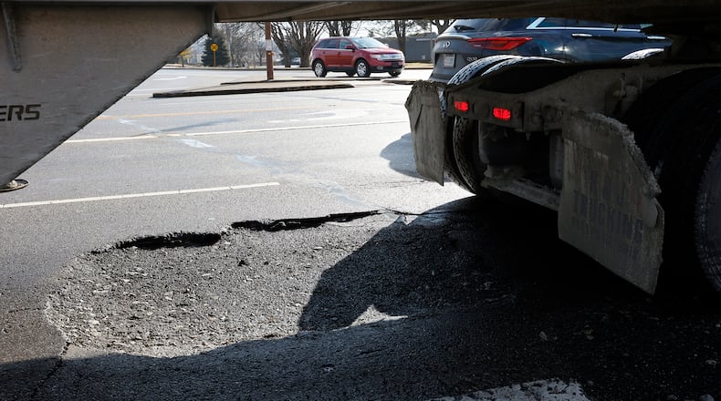 A large pothole on Dryden Road near Main Street in Moraine. MARSHALL GORBY\STAFF