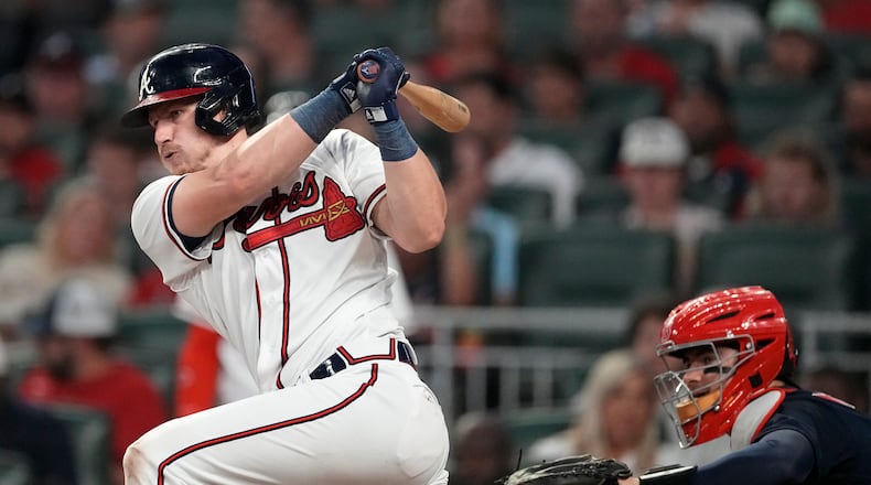 Atlanta Braves' Sean Murphy (12) drives in two runs with a base hit as Boston Red Sox catcher Reese McGuire (3) looks on in the fourth inning of a baseball game Tuesday, May 9, 2023, in Atlanta. (AP Photo/John Bazemore)