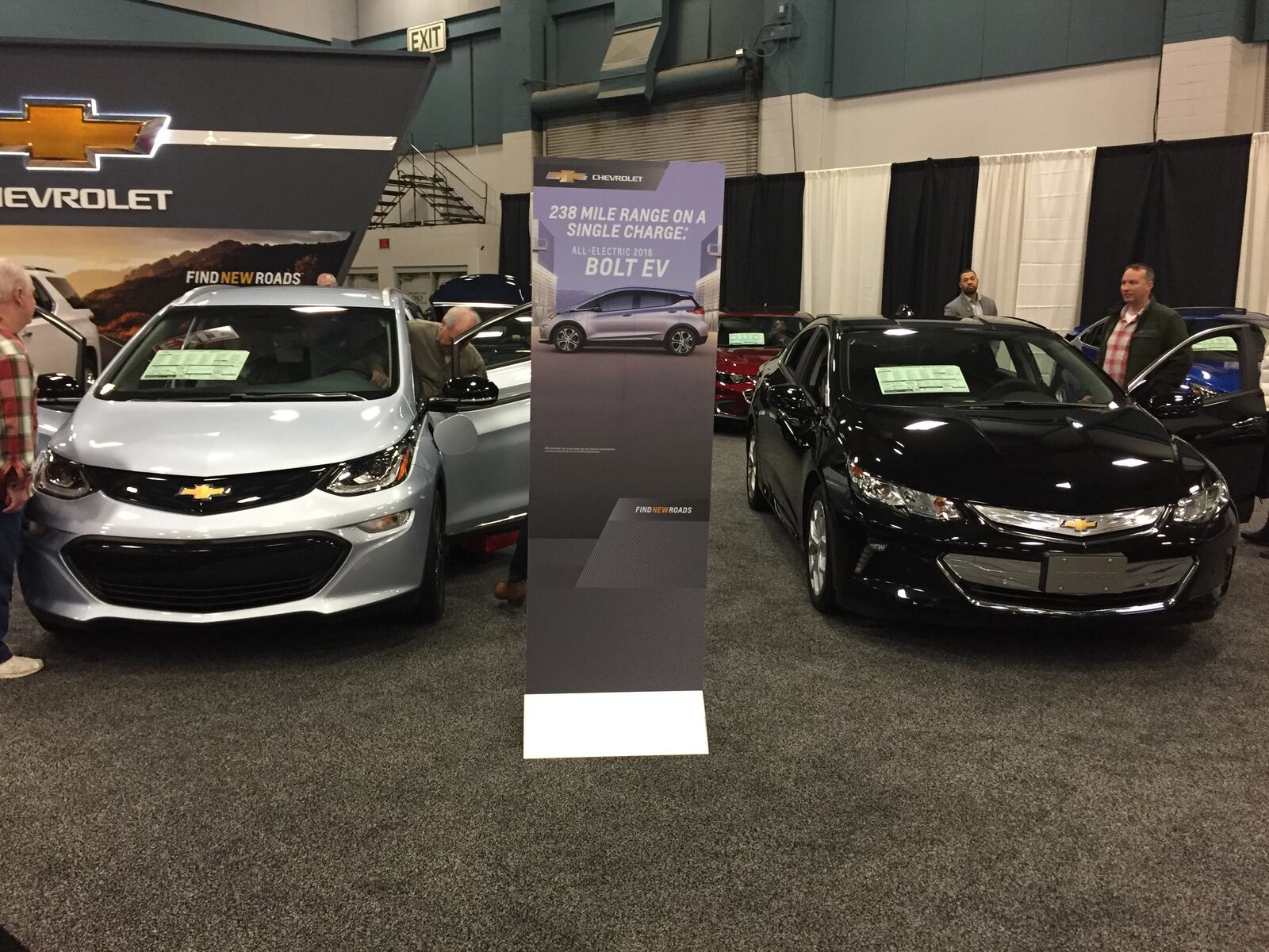 The Chevrolet Bolt, left, and Volt are two of the many hybrids at the 2018 Dayton Auto Show. AMY ROLLINS / STAFF