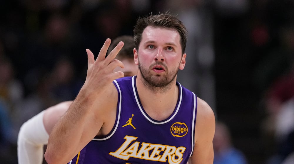 Los Angeles Lakers guard Luka Doncic (77) gestures after a three-point basket against the Indiana Pacers during the first half of an NBA basketball game in Indianapolis, Wednesday, March 25, 2026. (AP Photo/Michael Conroy)