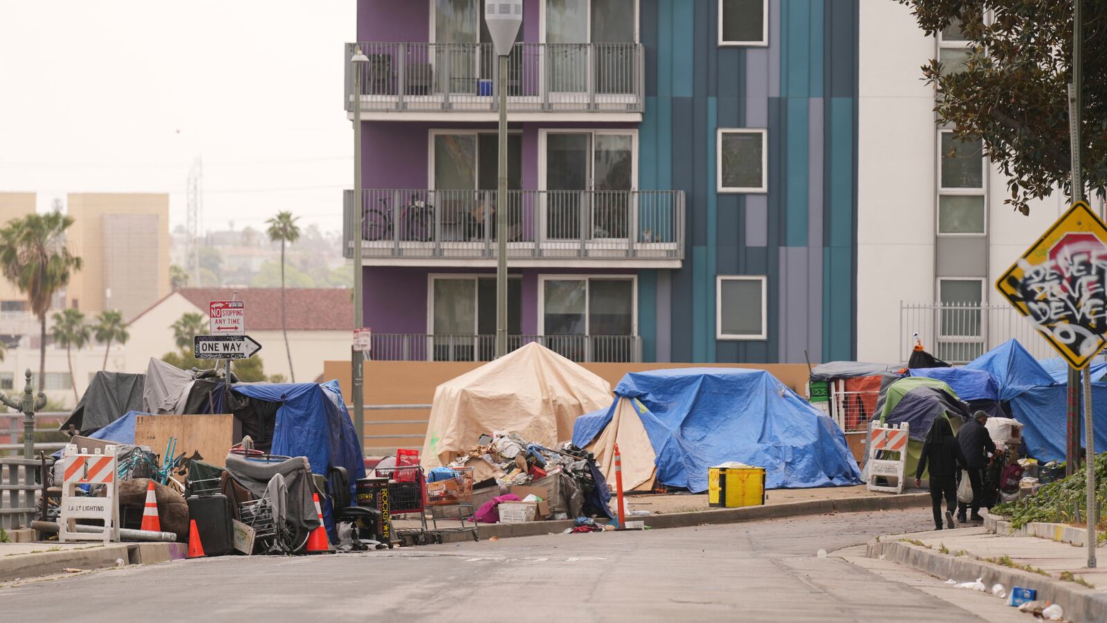 Tents are set up along a freeway in a homeless encampment Monday, May 12, 2025, in Los Angeles. (AP Photo/Damian Dovarganes)