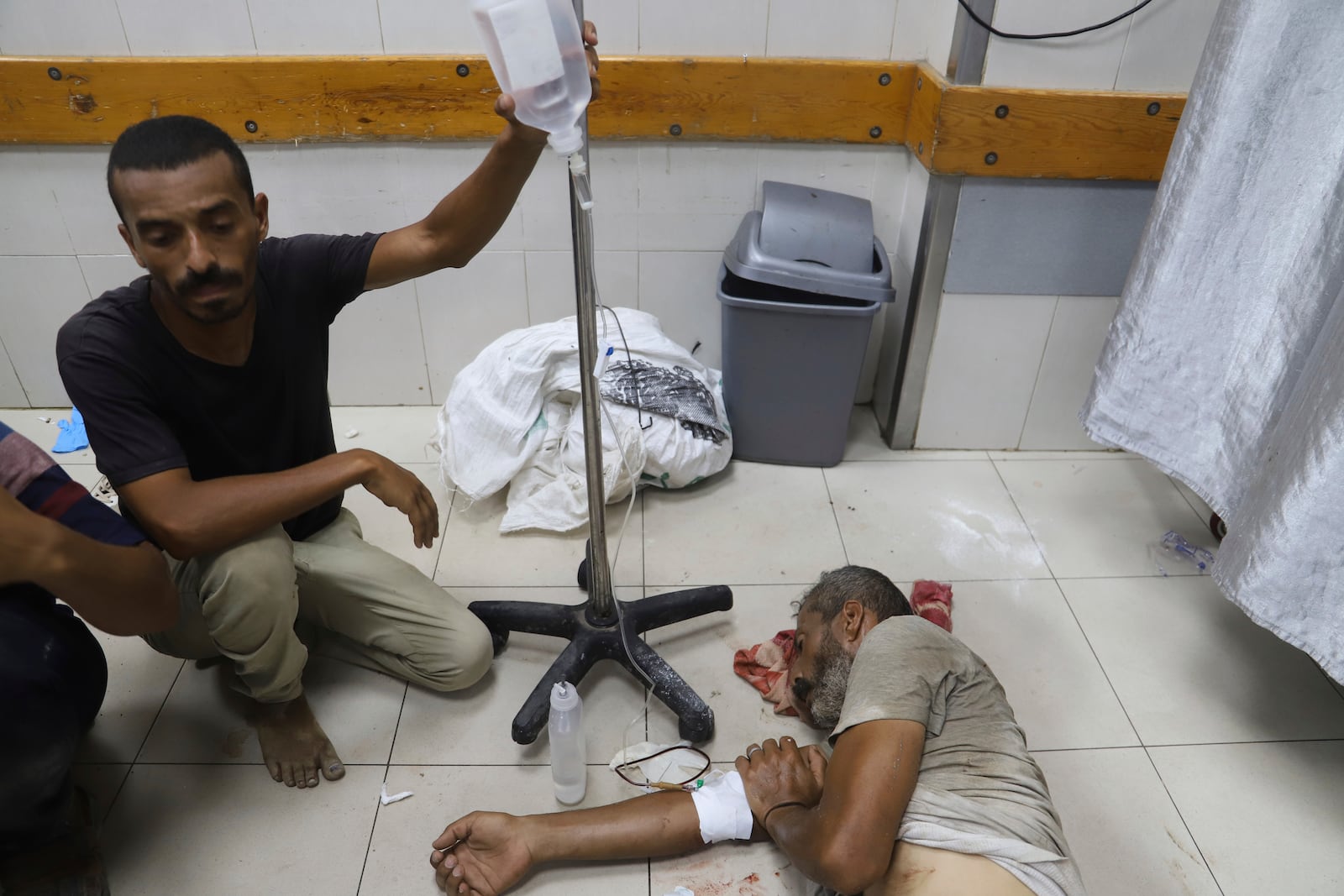 A Palestinian wounded while returning from one of the Gaza Humanitarian Foundation distribution centers operated by the U.S.-backed organization, according to Nasser Hospital, are treated in Khan Younis, Monday, June 30, 2025. (AP Photo/Mariam Dagga)