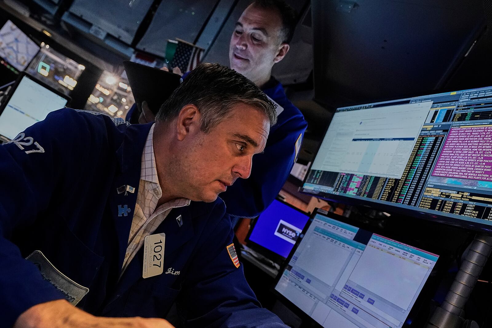 Traders James Bodner, foreground, and Christopher Lagana work on the floor of the New York Stock Exchange, Friday, July 18, 2025. (AP Photo/Richard Drew)