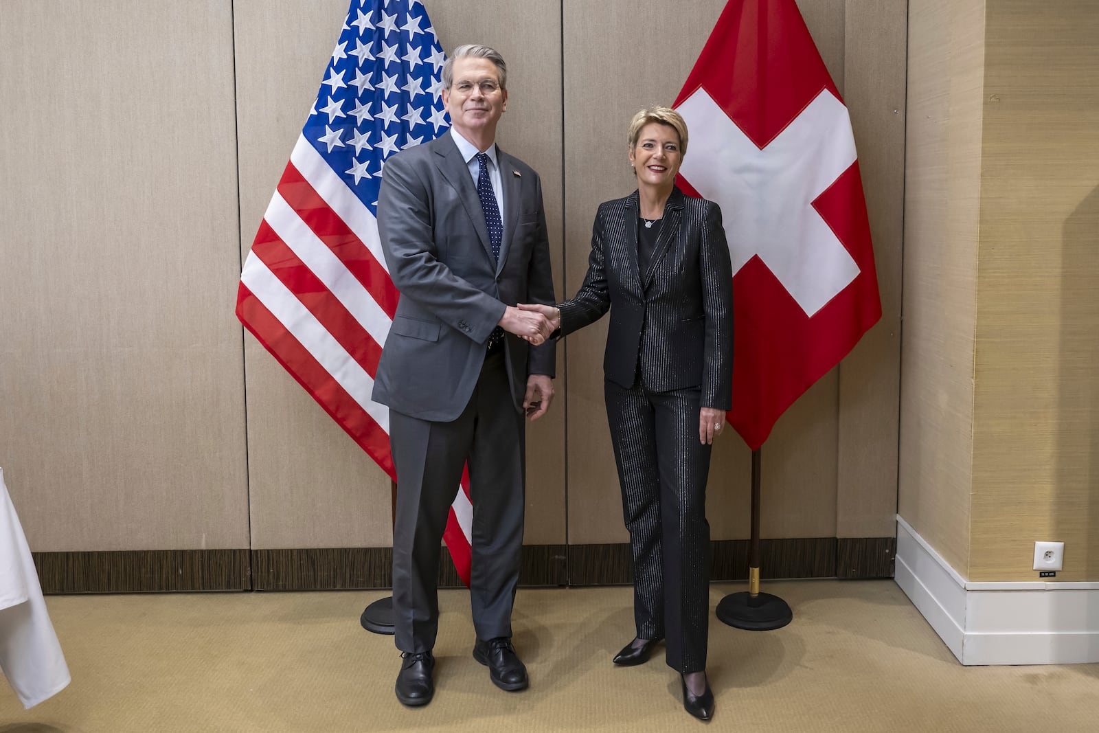 US Secretary of the Treasury Scott Bessent, left, shakes hands with Switzerland's President Karin Keller-Sutter, right, during a bilateral meeting between Switzerland and the United States, in Geneva, Switzerland, on Friday, May 9, 2025. (Martial Trezzini/Keystone via AP)