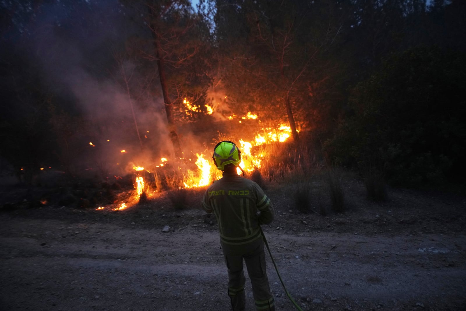 An Israeli firefighter works as forest fire is burning near Jerusalem, Wednesday, April 30, 2025. (AP Photo/Ohad Zwigenberg)