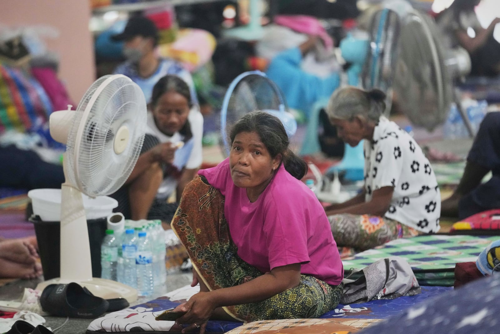 Thai residents who fled homes following the clashes between Thai and Cambodian soldiers, rest at an evacuation center in Surin province, Thailand, Wednesday, July 30, 2025. (AP Photo/Sakchai Lalit)