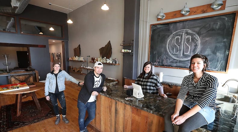 Four local artists, from left, Allison Dudney, Derrick Snowden, Corey White, Valerie Rieker have pooled their talents in a new home and bath store in downtown Springfield called Stick and Stone. Bill Lackey/Staff