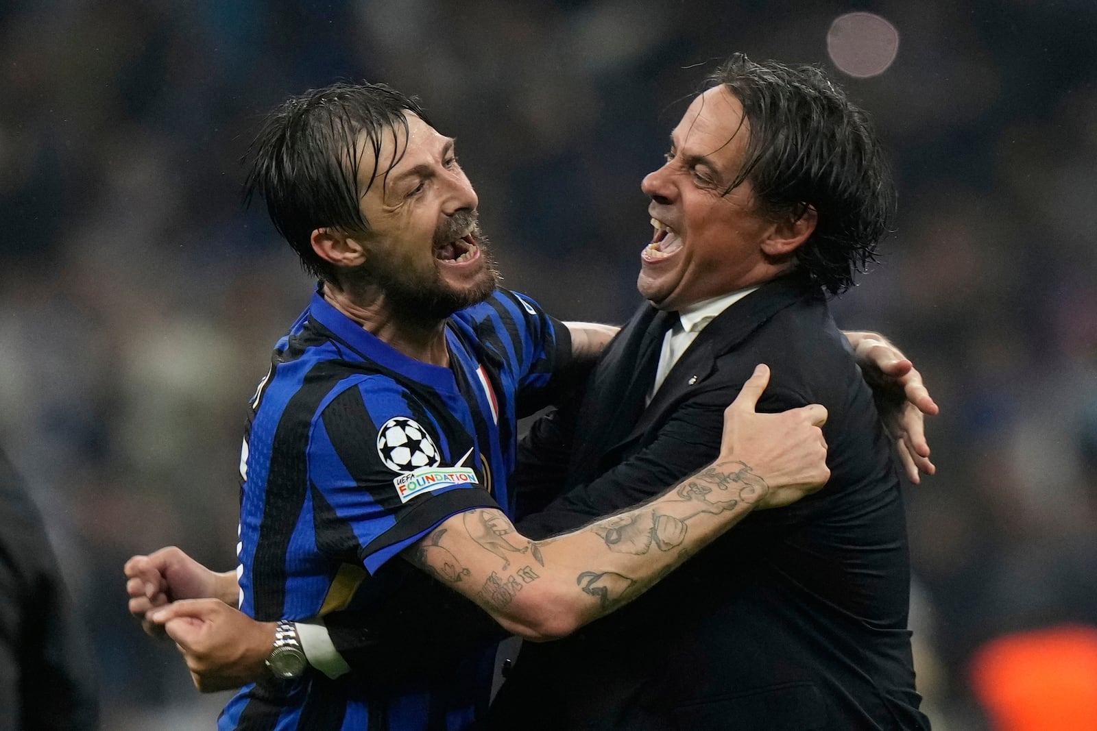 Inter Milan's head coach Simone Inzaghi, right, celebrates with Inter Milan's Francesco Acerbi at the end of the Champions League semifinal second leg soccer match between Inter Milan and Barcelona at San Siro stadium in Milan , Italy, Tuesday, May 6, 2025. (AP Photo/Luca Bruno)