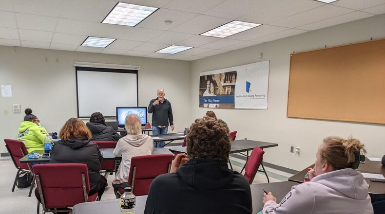 The new Neighborhood Housing Partnership office at 629 South Center Street is already hosting educational programs for those interested in developing a stronger financial footing so they can become home owners.  Pictured is Project Manager James Klay offering instruction to a new class of potential home owners.