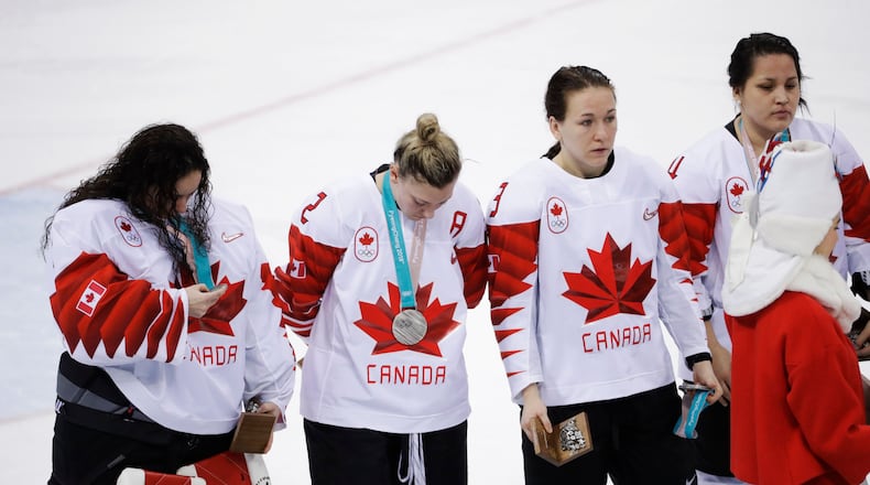 Jocelyne Larocque holds her silver medal after quickly taking it off her neck after Canada lost to the USA.