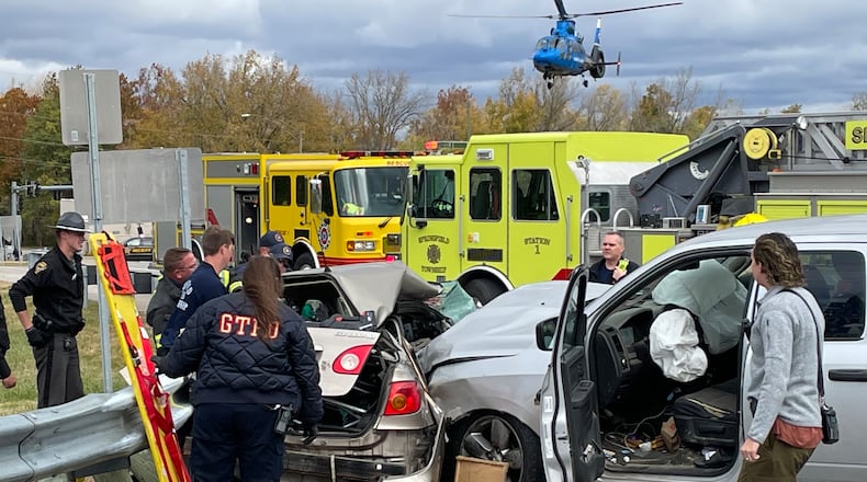 One person was taken by medical helicopter following a two-vehicle crash that caused multiple injuries Tuesday, Oct. 18, 2022, at Upper Valley Pike and state Routes 4/40 in Springfield Twp. BILL LACKEY/STAFF
