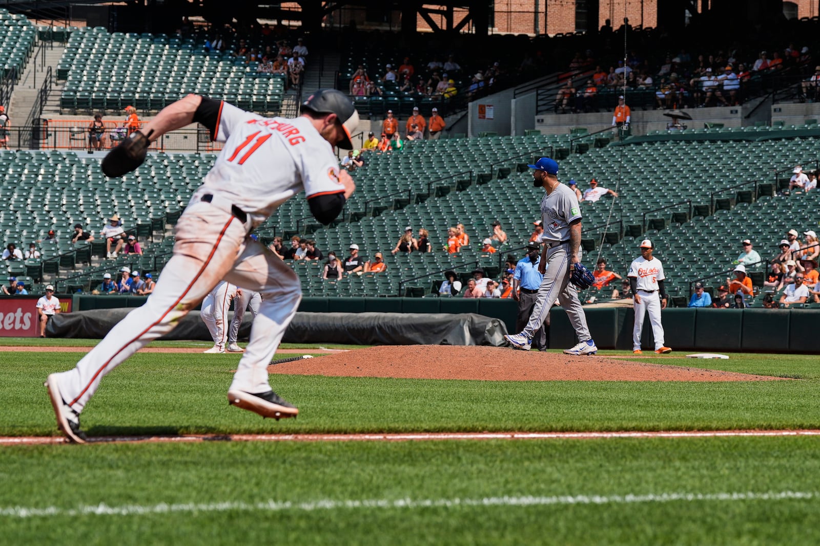 Baltimore Orioles' Jordan Westburg (11) advances toward home plate to score on a sacrifice fly hit by Jackson Holliday as Toronto Blue Jays position player Ali Sanchez pitches during the eighth inning in the first baseball game of a doubleheader, Tuesday, July 29, 2025, in Baltimore. (AP Photo/Stephanie Scarbrough)