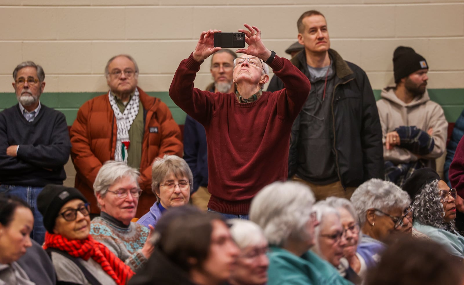 An audience member films the estimated 1,200 attendees of Here We Stand: Faith Leaders for Immigration Justice & Family Unity at St. John Missionary Baptist Church on Monday, Feb. 2, 2026, in Springfield. The venue was over capacity as pastors, faith leaders and community members gathered to pray and call for the extension of Temporary Protected Status, which is scheduled to expire on Tuesday, Feb. 3, 2026. JOSEPH COOKE/STAFF