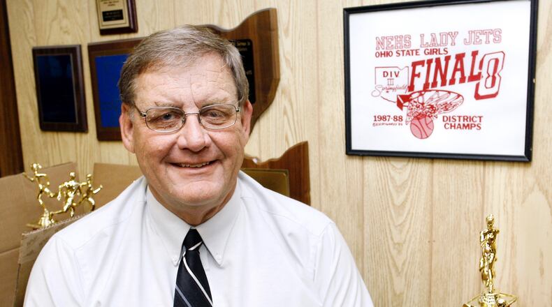 Jim Murray, retiring Northeastern Athletic Director, sits in his office among some of the many awards that Northeastern athletes have won over the years. Staff Photo by Barbara J. Perenic