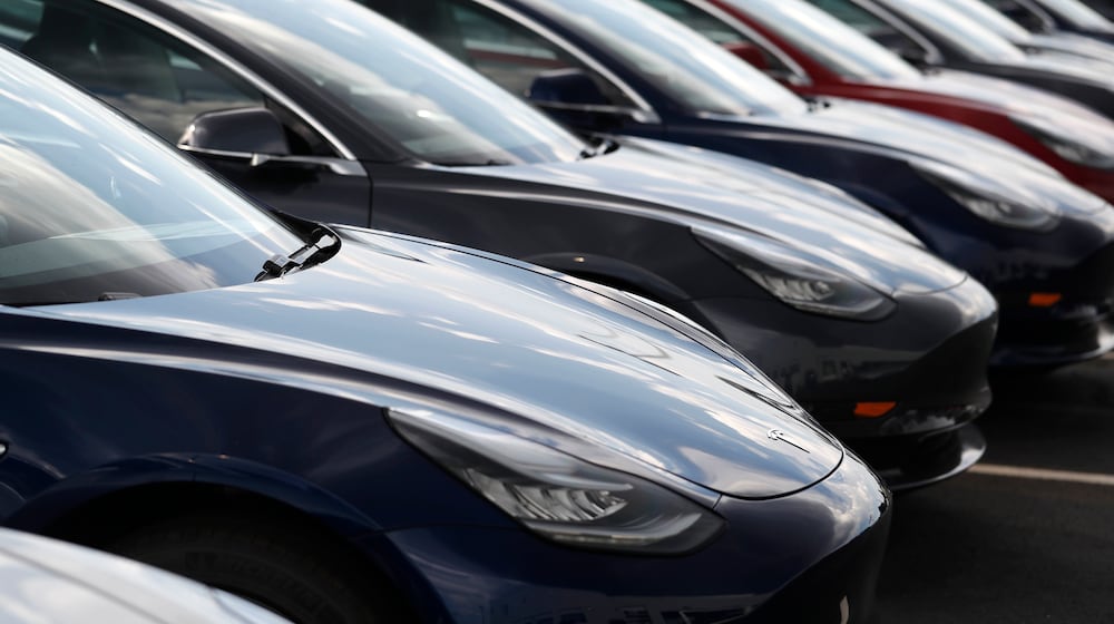 FILE - Several 2018 Model 3 sedans sit on display outside a Tesla showroom, July 8, 2018, in Littleton, Colo. (AP Photo/David Zalubowski, File)