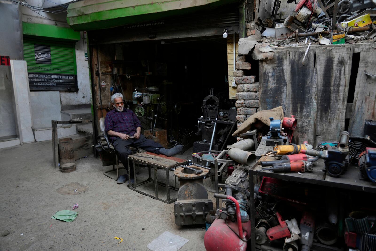 Bashir Ahmad, a Kashmiri shopkeeper, rests at his shop inside the Auqaf Market in Srinagar, Indian controlled Kashmir, Wednesday, April 2, 2025. (AP Photo/Mukhtar Khan)
