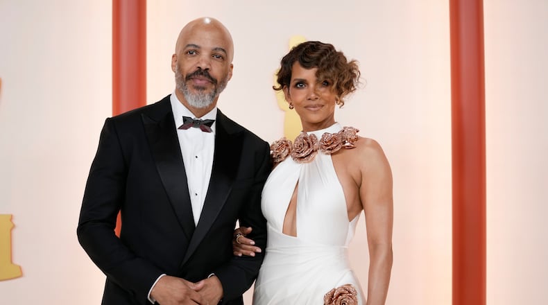 Van Hunt, left, and Halle Berry arrive at the Oscars on Sunday, March 12, 2023, at the Dolby Theatre in Los Angeles. (AP Photo/Ashley Landis)