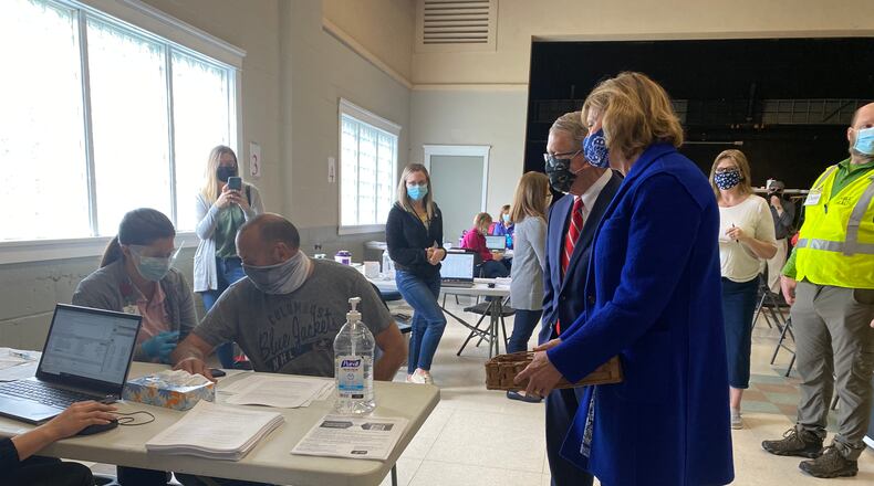 Ohio Gov. Mike DeWine and Ohio First Lady Fran DeWine (right) look on as Barry Gertner, 54, gets a COVID-19 vaccine at a vaccination clinic in Piqua on Saturday, March 27, 2021. EILEEN McCLORY / STAFF