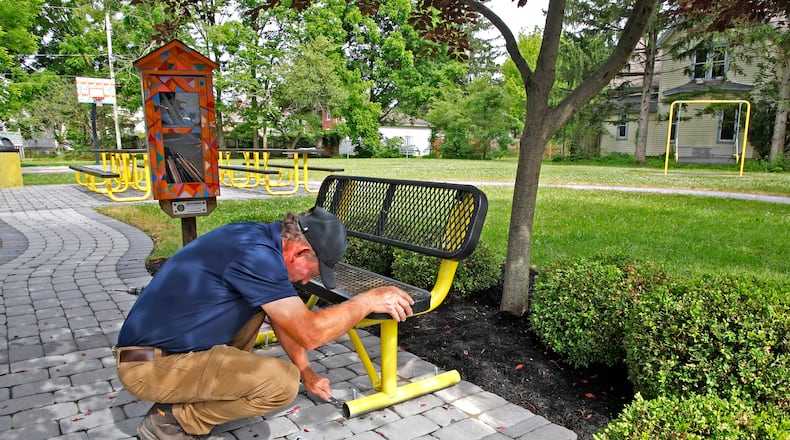 George Roach, from George's Landscaping, puts the finishing touches of a neighborhood park along Woodward Avenue in Springfield Thursday, June 6, 2024. The park will be officially dedicated Saturday to Sully Jaymes, the city's first Black attorney. BILL LACKEY/STAFF