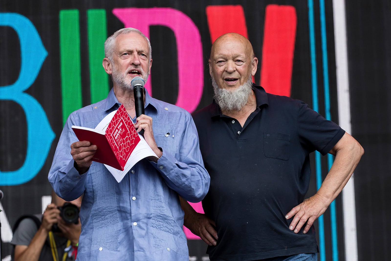 FILE - Britain's Labour Party leader Jeremy Corbyn, left, and organizer Michael Eavis appear onstage at the Glastonbury Festival at Worthy Farm, in Somerset, England, June 24, 2017. (Photo by Grant Pollard/Invision/AP, file)