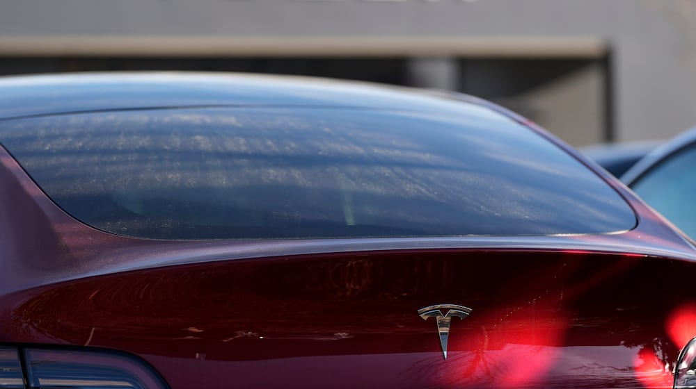 FILE - A Tesla model Y and other Telsla vehicles sit at a dealership, Wednesday, March 19, 2025, in Kennesaw, Ga. (AP Photo/Mike Stewart, File)