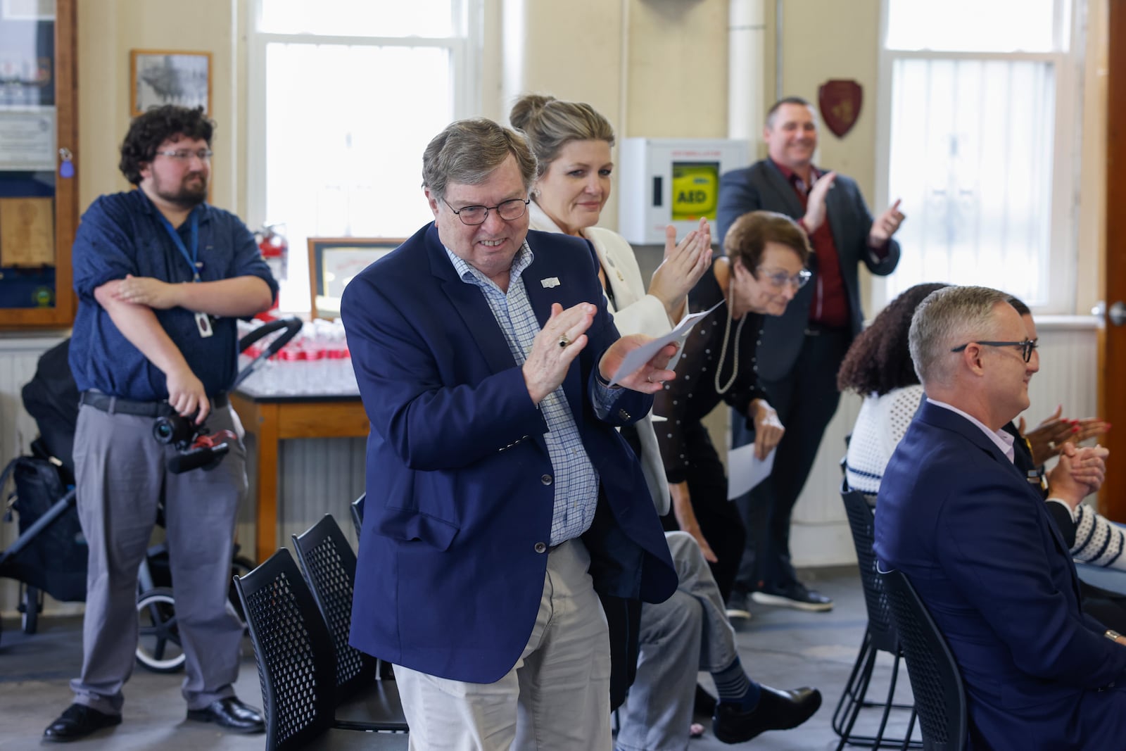 Assistant mayor David Estrop, center, claps at the end of a speech during a renaming ceremony on Wednesday, May 7, 2025, for police sub station on West Johnny Lytle Avenue. The sub station will be named after former police chief Roger Evans, who died in 2024. JOSEPH COOKE/STAFF