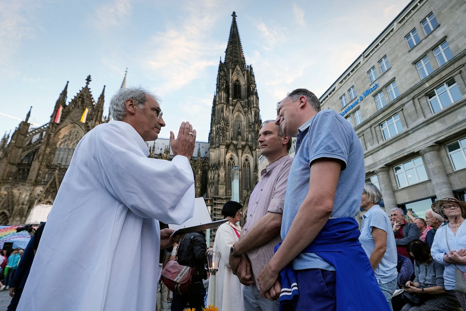 FILE - Same-sex couples take part in a public blessing ceremony in front of the Cologne Cathedral in Cologne, Germany, Sept. 20, 2023. (AP Photo/Martin Meissner, File)