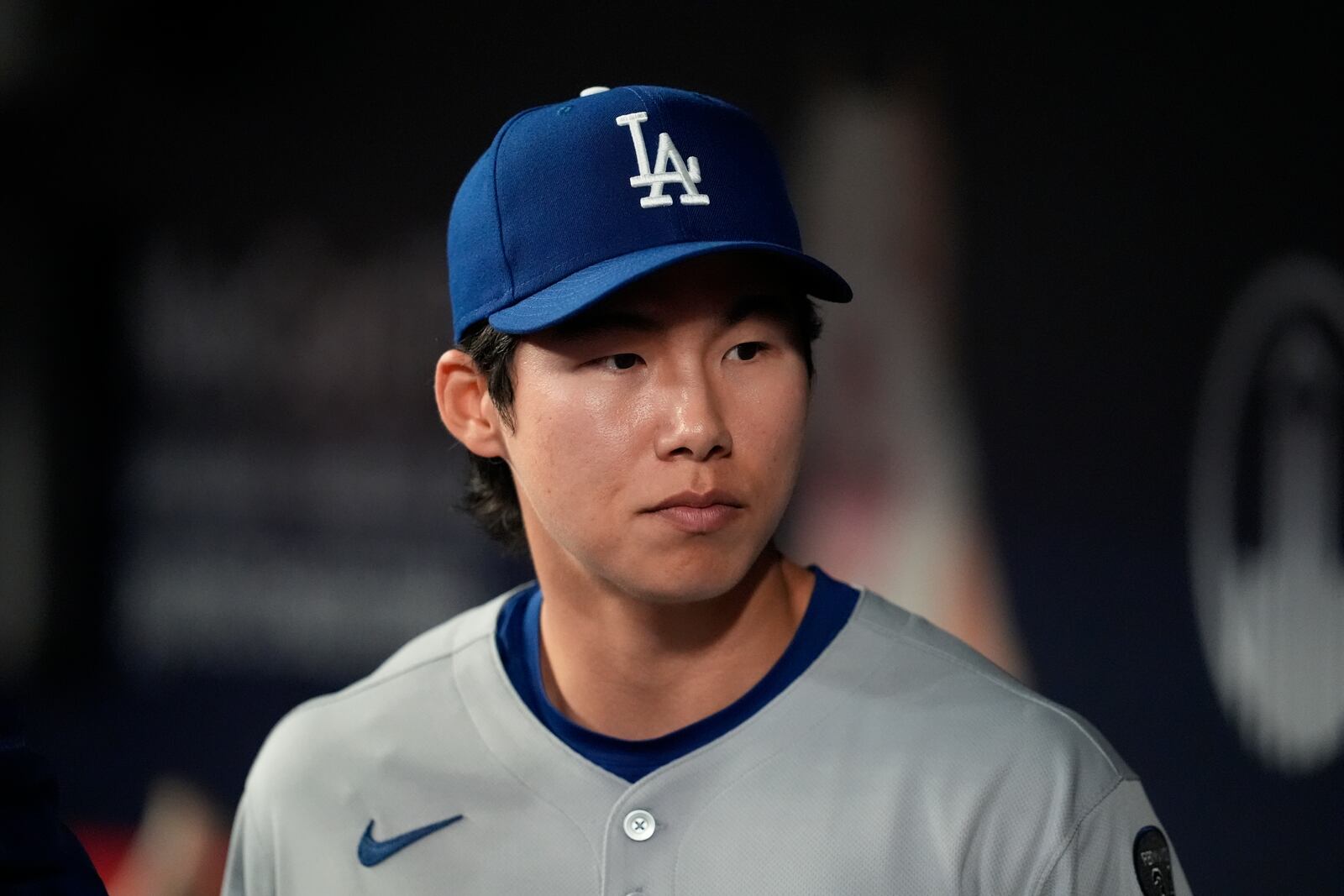 Los Angeles Dodgers' Hyeseong Kim stands in the dugout in the ninth inning of a baseball game against the Atlanta Braves, Sunday, May 4, 2025, in Atlanta. (AP Photo/Mike Stewart)