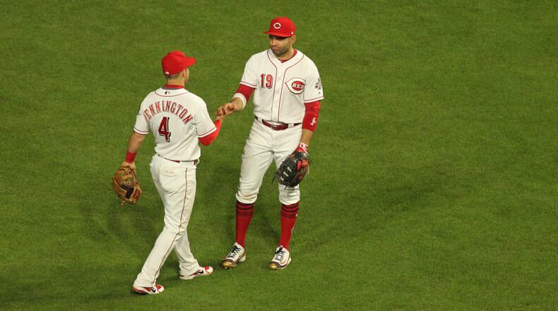 The Reds celebrate a victory against the Braves on Monday, April 23, 2018, at Great American Ball Park in Cincinnati.