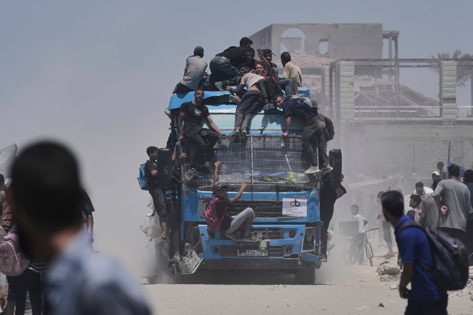 Palestinians hold onto an aid truck returning to Gaza City from the northern Gaza Strip on Tuesday, July 22, 2025. (AP Photo/Jehad Alshrafi)