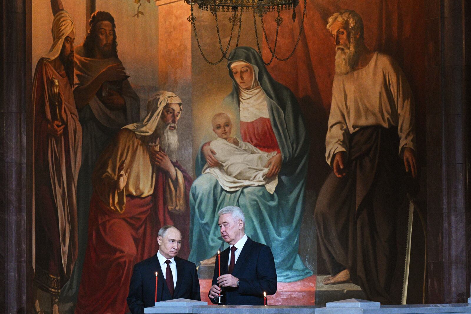 Russian President Vladimir Putin, left, and Moscow Mayor Sergei Sobyanin attend the Orthodox Easter service at Christ the Saviour Cathedral in Moscow, Russia, Saturday, April 19, 2025. (Ramil Sitdikov/Sputnik/Kremlin Pool Photo via AP)