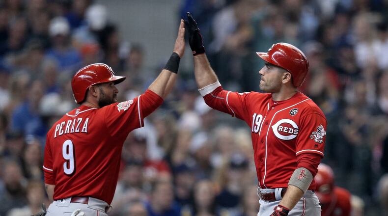 MILWAUKEE, WISCONSIN - JUNE 23: Jose Peraza #9 and Joey Votto #19 of the Cincinnati Reds celebrate after Votto hit a home run in the sixth inning against the Milwaukee Brewers at Miller Park on June 23, 2019 in Milwaukee, Wisconsin. (Photo by Dylan Buell/Getty Images)