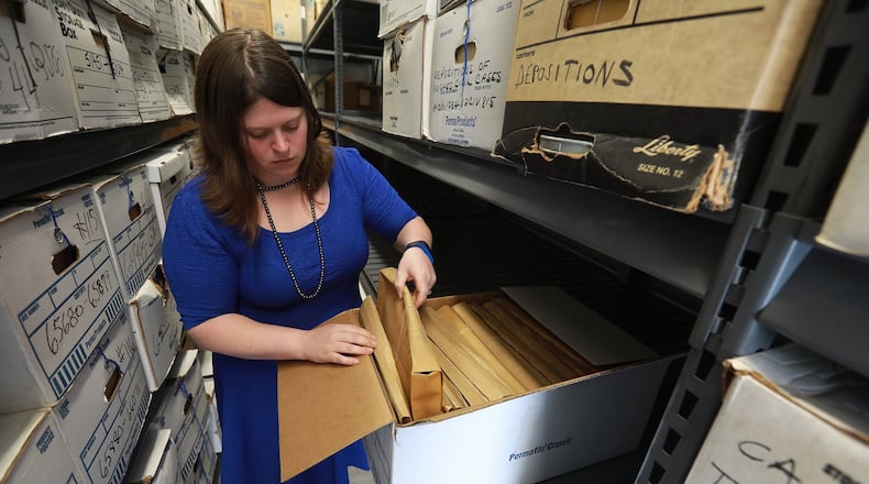 Melissa Tuttle, Clark County Clerk of Courts, looks through a records box in the newly organized off site storage unit at Springview Government Center. BILL LACKEY/STAFF