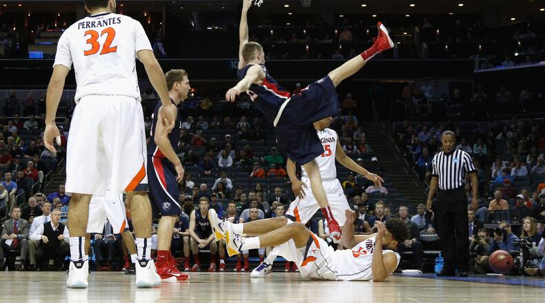 CHARLOTTE, NC - MARCH 20: Evan Bradds #35 of the Belmont Bruins falls at the basket against the Virginia Cavaliers during the second round of the 2015 NCAA Men’s Basketball Tournament at Time Warner Cable Arena on March 20, 2015 in Charlotte, North Carolina. (Photo by Bob Leverone/Getty Images)