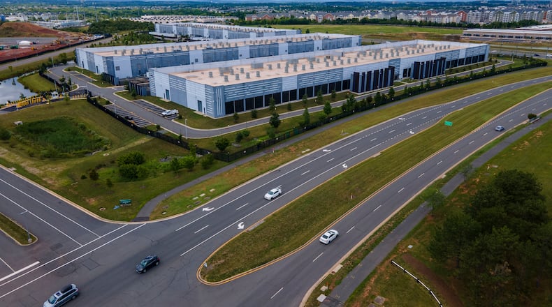 FILE - Cars drive past data centers that house computer servers and hardware required to support modern internet use, such as artificial intelligence, in Ashburn, Virginia, July 16, 2023. (AP Photo/Ted Shaffrey, File)