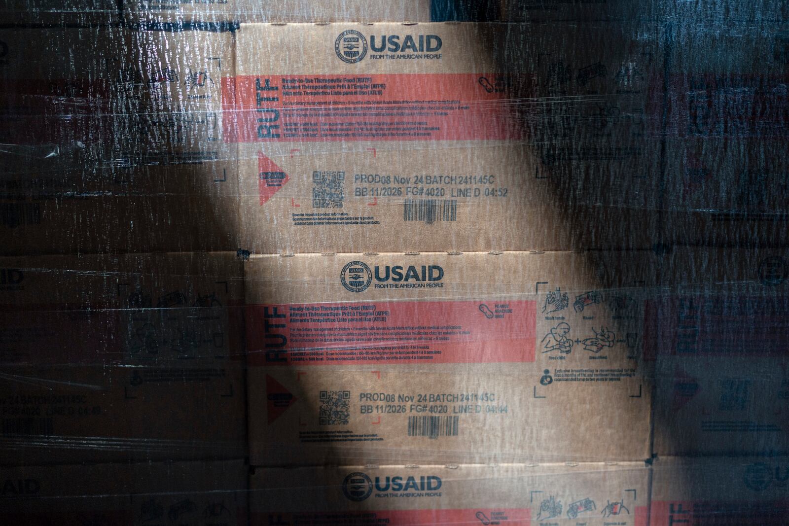Boxes of Plumpy'Nut, a nutritional lifesaving peanut paste sent to malnourished children worldwide, are labeled with "USAID" as they sit waiting to be shipped from Edesia Nutrition's warehouse, Friday, March 14, 2025, in North Kingstown, R.I. (AP Photo/David Goldman)