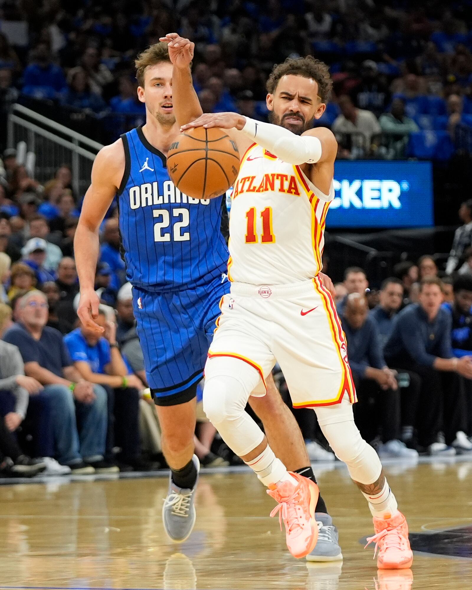 Atlanta Hawks guard Trae Young (11) is fouled by Orlando Magic forward Franz Wagner (22) on a drive to the basket during the first half of an NBA play-in tournament basketball game, Tuesday, April 15, 2025, in Orlando, Fla. (AP Photo/John Raoux)
