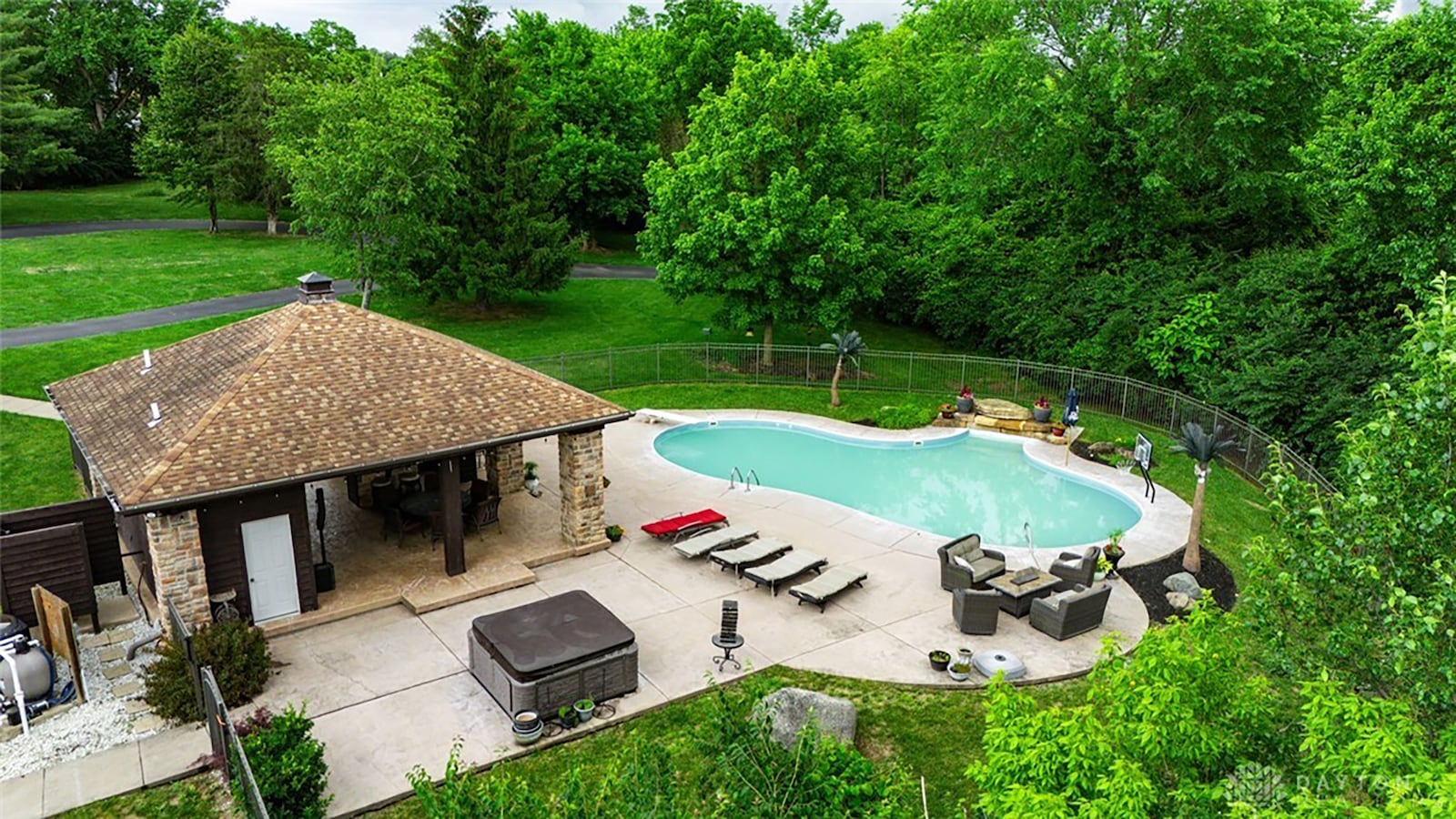 The property also has an inground saltwater pool and pool house with covered patio and hot tub. It is surrounded by a metal fence. CONTRIBUTED