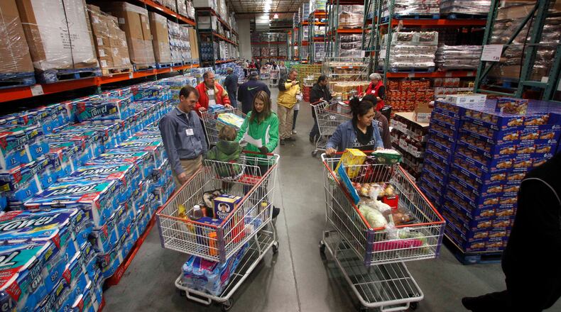 ORG XMIT: ORRB206 This photo taken Dec. 7, 2011, shows customers shopping at a Costco, in, Portland, Ore. Wholesale companies increased their stockpiles of autos, paper, and other goods in October by the most in five months, a sign they expect consumer demand to rise. (AP Photo/Rick Bowmer)