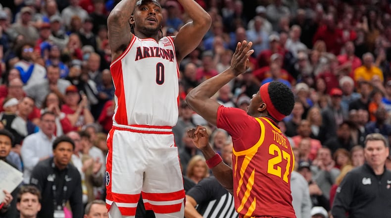 Arizona's Jaden Bradley (0) makes a game-winning basket over Iowa State's Killyan Toure at the buzzer to defeat Iowa State during an NCAA college basketball game in the semifinal round of the Big 12 Conference tournament Friday, March 13, 2026, in Kansas City, Mo. (AP Photo/Charlie Riedel)