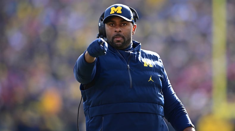 FILE - Michigan acting head coach Sherrone Moore reacts to a video replay during the first half of an NCAA college football game against Ohio State, Saturday, Nov. 25, 2023, in Ann Arbor, Mich. (AP Photo/David Dermer, File)
