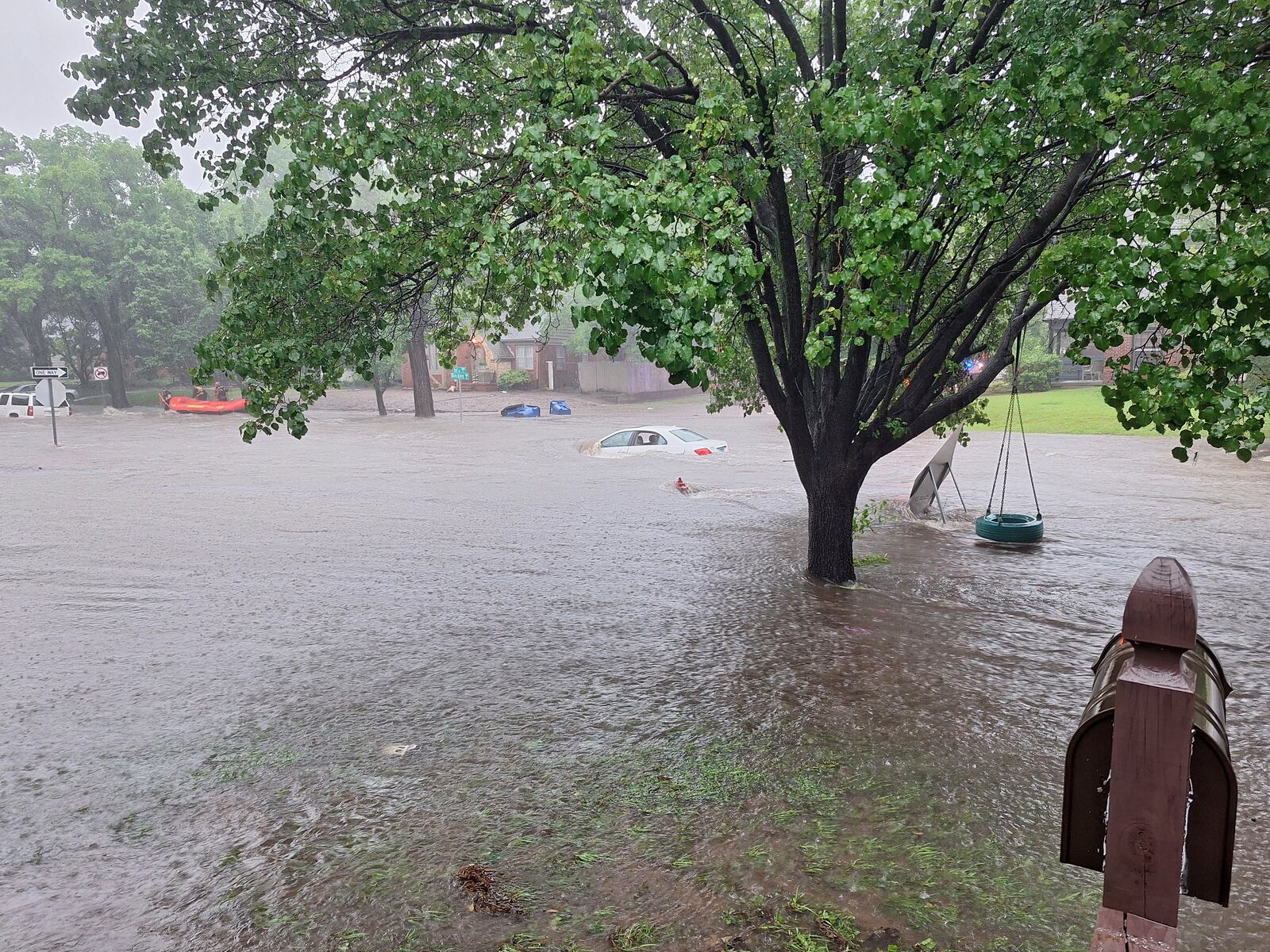 This photo provided by Colin Fee, a vehicle is surrounded by flood waters as heavy rains caused flash flooding in the Wichita area of south-central Kansas forcing firefighters to rescue dozens of people, including stranded motorists on Tuesday, June 3, 2025. (Colin Fee via AP)