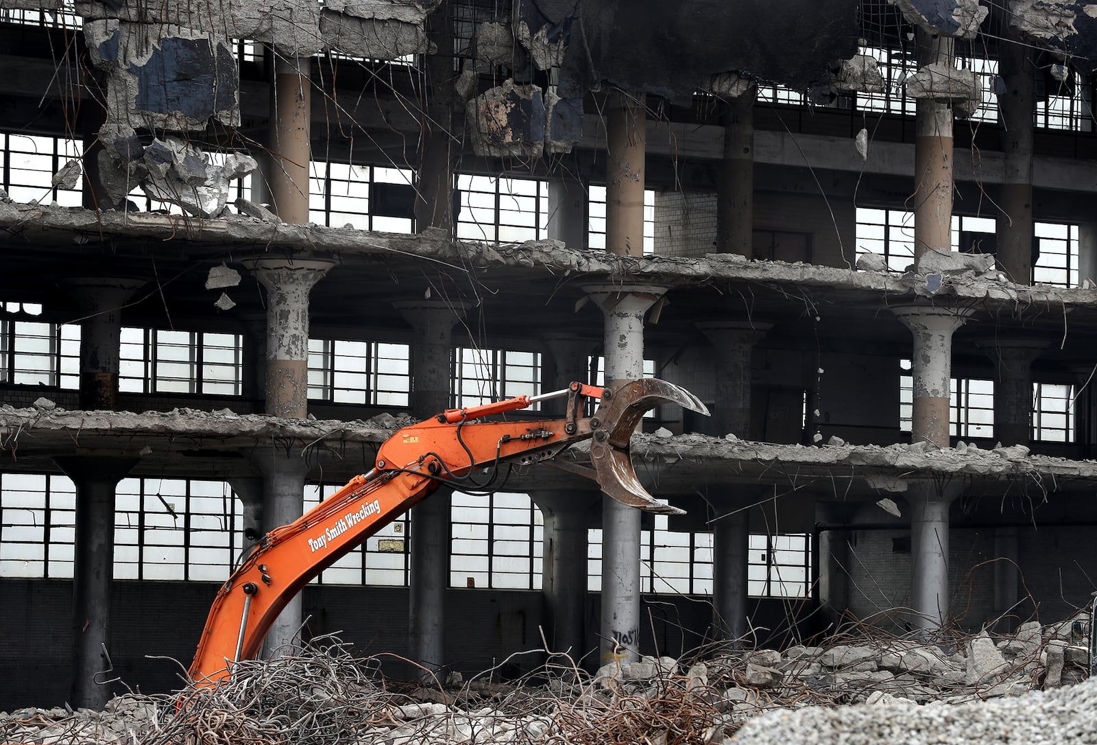 A claw seems to reach out of the ground as the crew from Tony Smith Wrecking works on the lower level of the remaining Crowell-Collier Building as they continue to demolish the old factory in downtown Springfield. BILL LACKEY/STAFF