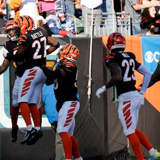 Cincinnati Bengals safety Geno Stone, left, celebrates with teammates after returning an interception for a touchdown during the first half of an NFL football game against the New England Patriots, Sunday, Nov. 23, 2025, in Cincinnati. (AP Photo/Jay LaPrete)