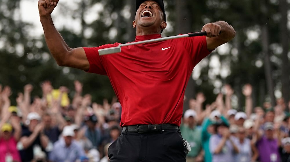 FILE - Tiger Woods reacts as he wins the Masters golf tournament, Sunday, April 14, 2019, in Augusta, Ga. (AP Photo/David J. Phillip, File)
