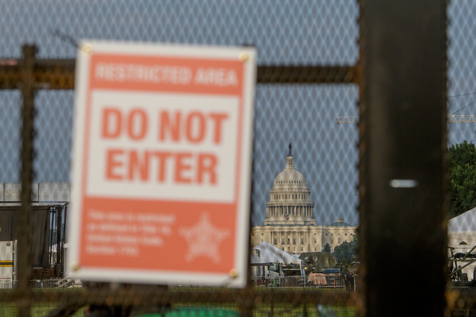 The U.S. Capitol is seen through security fencing, set up on the National Mall, during preparations for an upcoming military parade commemorating the Army's 250th anniversary and coinciding with President Donald Trump's 79th birthday, Thursday, June 12, 2025, in Washington. (AP Photo/Rod Lamkey, Jr.)