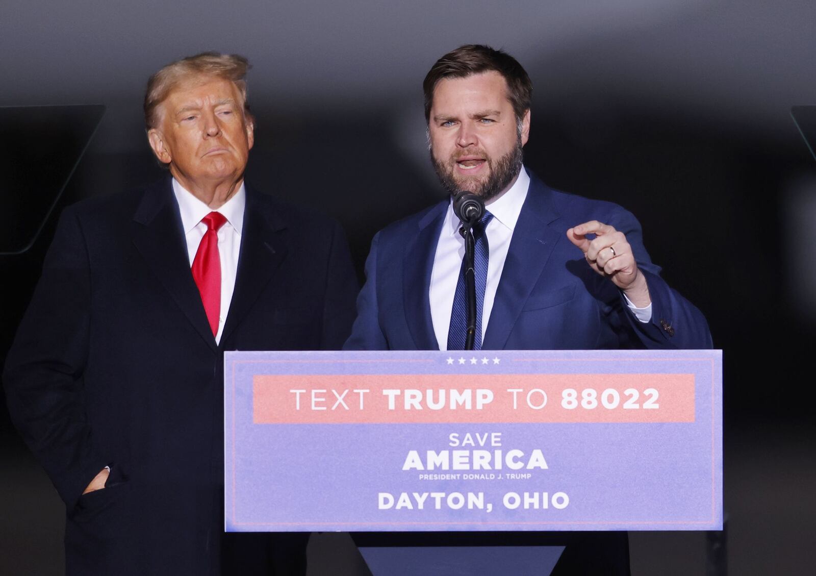 Donald Trump, left, brought J.D. Vance up to speak during a rally Monday, Nov. 7, 2022 at Dayton International Airport. NICK GRAHAM/STAFF